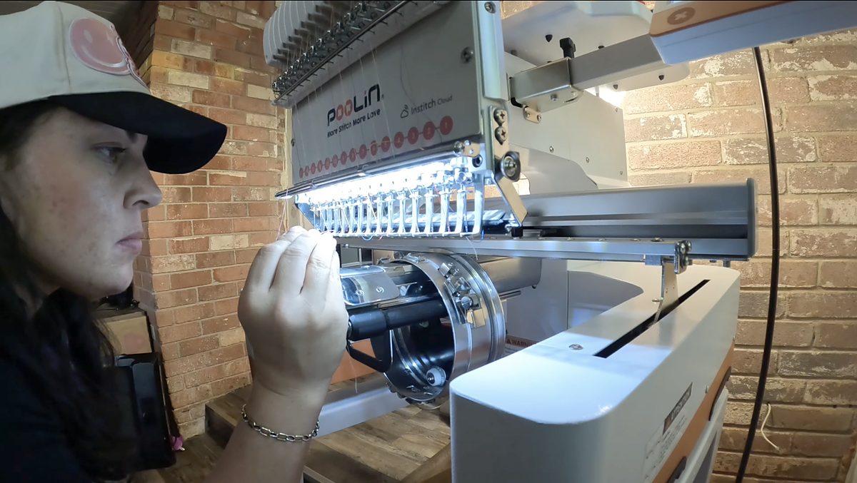 Stephanie operating the embroidery machine