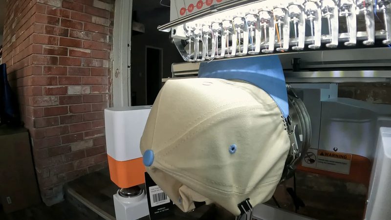 The needle stitching the design into the garment
