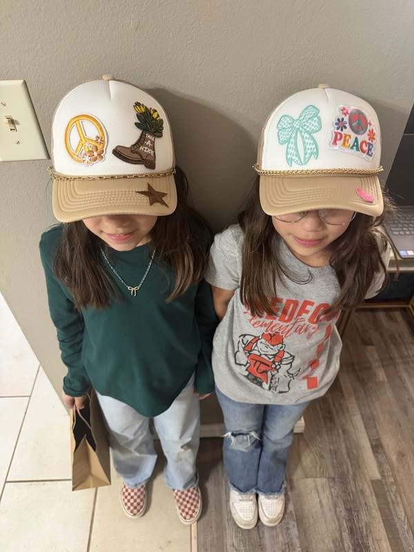 Two girls wearing custom patch caps