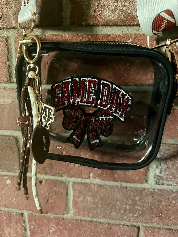 A close view of a sequin and chenille patch attached to the front of a clear stadium bag.