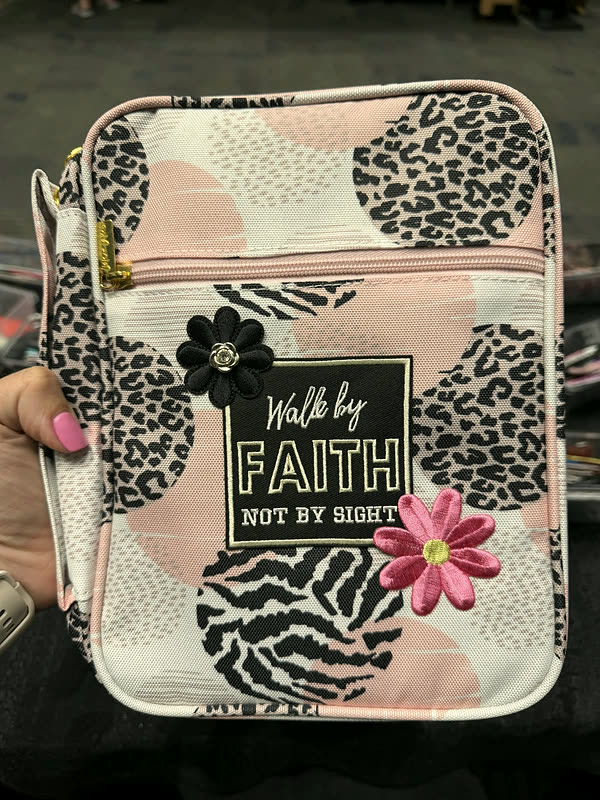A pink and black animal-print book cover with a rectangular word patch and two flowers.