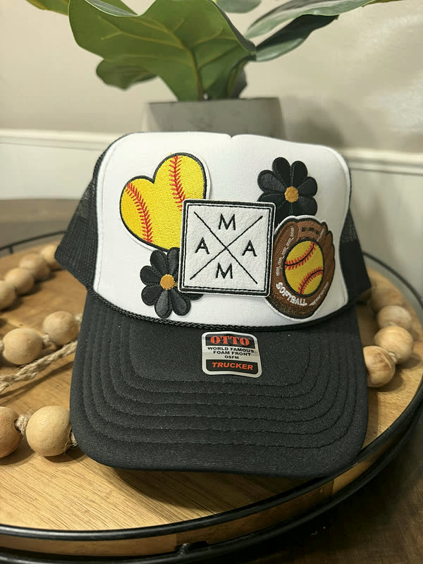 A charcoal cap with a diamond-shaped patch, two ball patches and a daisy across the front.