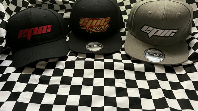 Three matching snapback caps carrying the same business logo in three colourways